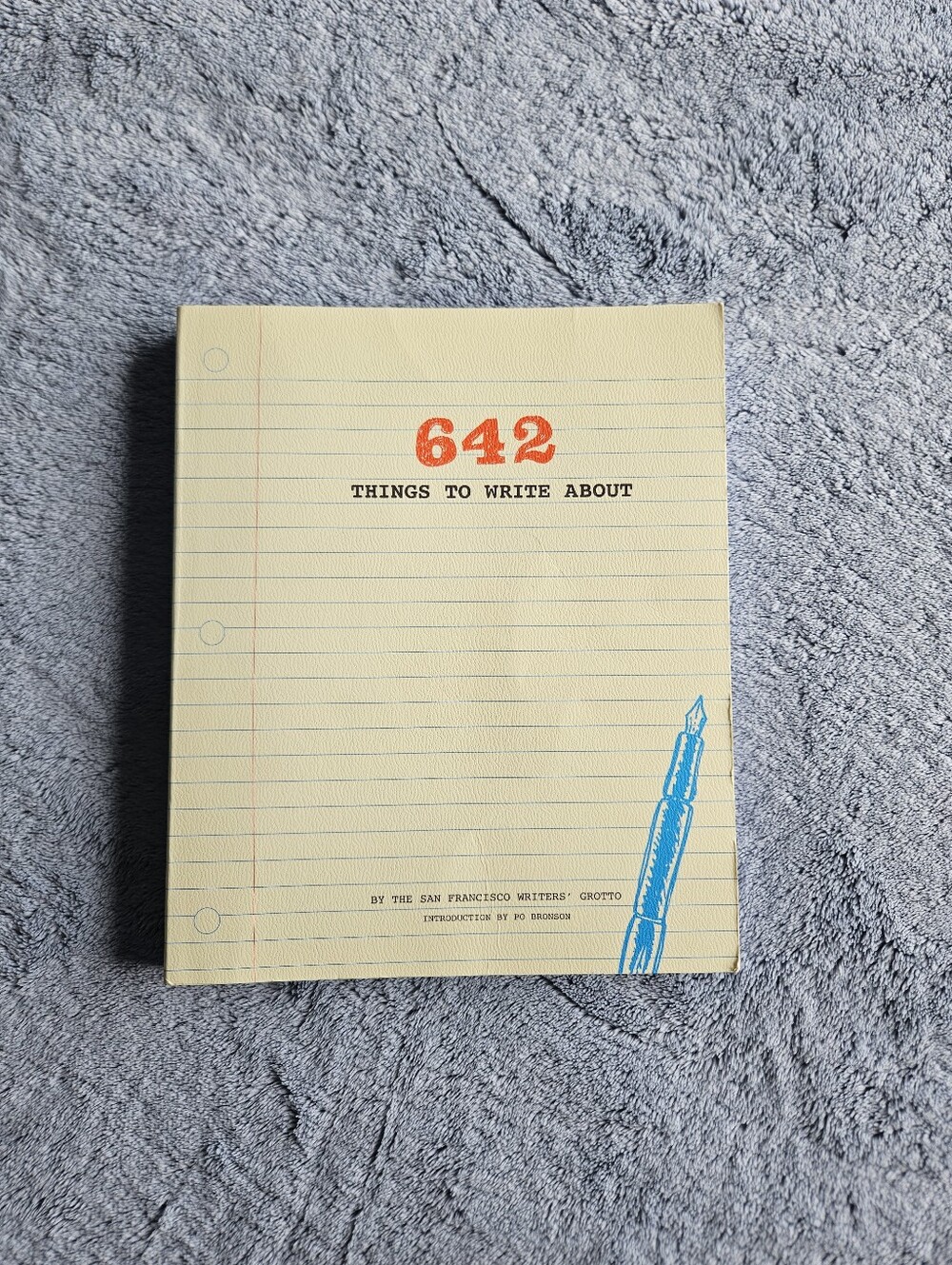 642 Things to Write About Notebook - Yellow Cover with Blue Pen Graphic